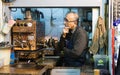 ISTANBUL, TURKEY - APRIL 2015: tea maker looking out of his kiosk at Grand Bazaar