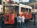 Tourists and local people travelling by historical red tramway | tramvay in Taksim Istiklal Street. Royalty Free Stock Photo