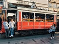 Tourists and local people travelling by historical red tramway | tramvay in Taksim Istiklal Street. Royalty Free Stock Photo