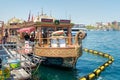 Traditional fast food bobbing boat serving fish sandwiches at Eminonu with chefs preparing meals, Istanbul, Turkey