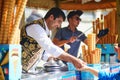 ISTANBUL, TURKEY - APRIL 25, 2023: Vendor serves the ice cream cone on a stick and then take it away when customer tries to grab