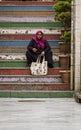 Istanbul, Turkey - April 29, 2022 - Woman sits on colored stairs