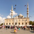 Crowds of citizens at Eminonu during the Victory Day holiday with the New Mosque in the background, Istanbul, Turkey