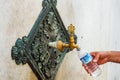 ISTANBUL, TURKEY - AUGUST 21, 2018: hand of man filling water bottle from crane of German Fountain`s. Royalty Free Stock Photo