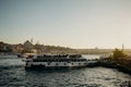 Tourist ship sails on the Golden Horn, scenic sunny beautiful waterfront of Istanbul city at sunset in summer