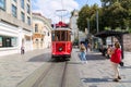 Istanbul, Turkey - August, 2018: Young girls tourists making photos of retro tram on Istiklal street. Red tram Taksim-Tunel. Icon
