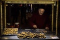 ISTANBUL, TURKEY - DECEMBER 28, 2015: Picture of an old chestnut seller on a cold winter evening on Istiklal street
