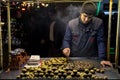 ISTANBUL, TURKEY - DECEMBER 28, 2015: Picture of an young chestnut seller on a cold winter evening on Istiklal street