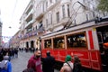 Taksim Tunel Nostalgia Tram trundles along the istiklal street and people at istiklal avenue. Istanbul, Turkey