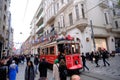 Taksim Tunel Nostalgia Tram trundles along the istiklal street and people at istiklal avenue. Istanbul, Turkey