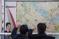ISTANBUL, TURKEY - DECEMBER 28, 2015: Two lost tourists looking and pointing at a map of istanbul public transport network