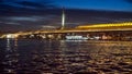 Istanbul, Turkey - February 2023: view on the calm sea water at Bosphorus at night and illuminated bridge to Golden Horn Royalty Free Stock Photo