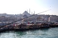 Fish sandwich shop boats in Eminonu Pier at to mouth of the Golden Horn Bay. Crowd of people outside in Eminonu Square, Istanbul, Royalty Free Stock Photo