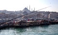 Fish sandwich shop boats in Eminonu Pier at to mouth of the Golden Horn Bay. Crowd of people outside in Eminonu Square, Istanbul, Royalty Free Stock Photo