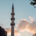Istanbul Turkey, high minaret of a mosque against a beautiful sky.
