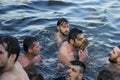 Istanbul, Turkey - January 6, 2018. A man retrieves a wooden cross during an Epiphany ceremony to bless the water. This ceremony m