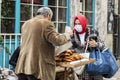 Woman buys traditional turkish bagel from a street simit vendor