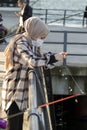 Young woman fisherman with a fishing rod on the shores of the Bosphorus. ÃÅskÃÂ¼dar