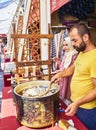 Workers boiling and unwinding silkworm cocoons to make silk thread at an Arab market of Istanbu Royalty Free Stock Photo