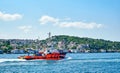 Istanbul, Turkey, July 147 2022, The red boat tug in the Bosphorus Strait, accompanies a cargo ship. View of the Asian Royalty Free Stock Photo