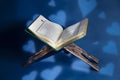 Istanbul, Turkey - June 1, 2018; An open page of Quran shows Surah Al-Baqarah on blue background. Quran is an Islamic holy book