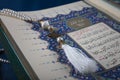 Istanbul, Turkey - June 1, 2018; An open page of Quran shows Surah Al-Baqarah on blue background. Quran is an Islamic holy book