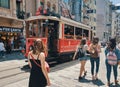 People walking or travelling by historical red tramway | tramvay in Taksim Istiklal Street Royalty Free Stock Photo