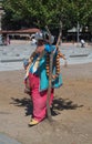 Istanbul, Turkey - June 29, 2012: turkish man with smiling face in colorful traditional oriental clothes standing under tree hidin