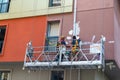 ISTANBUL / TURKEY - JUNE 17, 2019: Two plasterers painters restoring the facade of the house Royalty Free Stock Photo