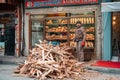 23.12.2019, Istanbul, Turkey. A man stands on the street next to a pile of firewood. In the background is the storefront of a