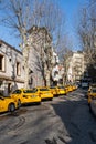 ISTANBUL, TURKEY - MARCH 25, 2023: old city street with yellow taxi cars and residential buildings