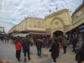 Istanbul, Turkey - March 8, 2019: People shopping in the Grand Bazar, handmade pillows, bags and carpets are on the wall for sale