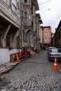 ISTANBUL, TURKEY - MARCH 23, 2023: Street with old traditional residential houses and filigree sidewalk