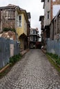 ISTANBUL, TURKEY - MARCH 23, 2023: Street with old traditional residential houses and filigree sidewalk