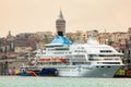 Celestyal Crystal cruise ship docked in Istanbul. Historical Galata Tower and buildings on the background. Popular tourism destina