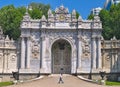 Dolmabahce palace, man walking in front of impressive entrance