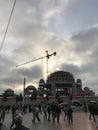 People walking around and cars in traffic at Taksim Square, Istanbul