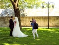 Istanbul. Turkey. May 5, 2016: Photographer takes a picture of a beautiful muslim wedding couple in the park Royalty Free Stock Photo