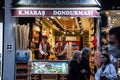 ISTANBUL, TURKEY - MAY 21, 2022: Selective blur on turkish ice cream sellers, selling dondurma, a traditional version of the ice- Royalty Free Stock Photo