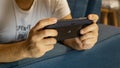 Guy playing with Sony PS Vita - handheld playstation gaming console