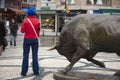 Funny moment of young woman and bull statue at Kadikoy