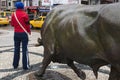 Funny moment of young woman and bull statue at Kadikoy