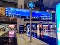Round clock and direction displays at Istanbul International Airport. Modern interior and