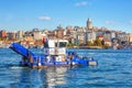 ISTANBUL, TURKEY -  October 9th, 2019: View to Galata Tower across Bay of Golden Horn. Special ship cleans the water in the Royalty Free Stock Photo