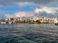 View from the sea to the Karakoy district with Galata Tower against the backdrop of a cloudy sky in Istanbul
