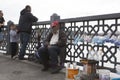 ISTANBUL / TURKEY - 30/05/2015: old tired Turkish street vendor of fishing lines, hooks, rigs, sitting and sleeping on Galata