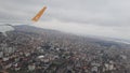 A Pegasus airline plane comes in for landing in Istanbul above the clouds at high altitude close up