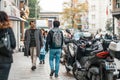 18.12.2019, Istanbul, Turkey. People walk through the streets of the capital. Motorcycles and mopeds are parked on the right