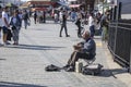 Istanbul, Turkey - September-14,2019:Artist performing music on the street. Pulled to his left. People walking around
