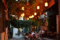 Bright lights,lamps and vine plant over street with cafe at summer evening in KarakÃÂ¶y,Istanbul. Royalty Free Stock Photo